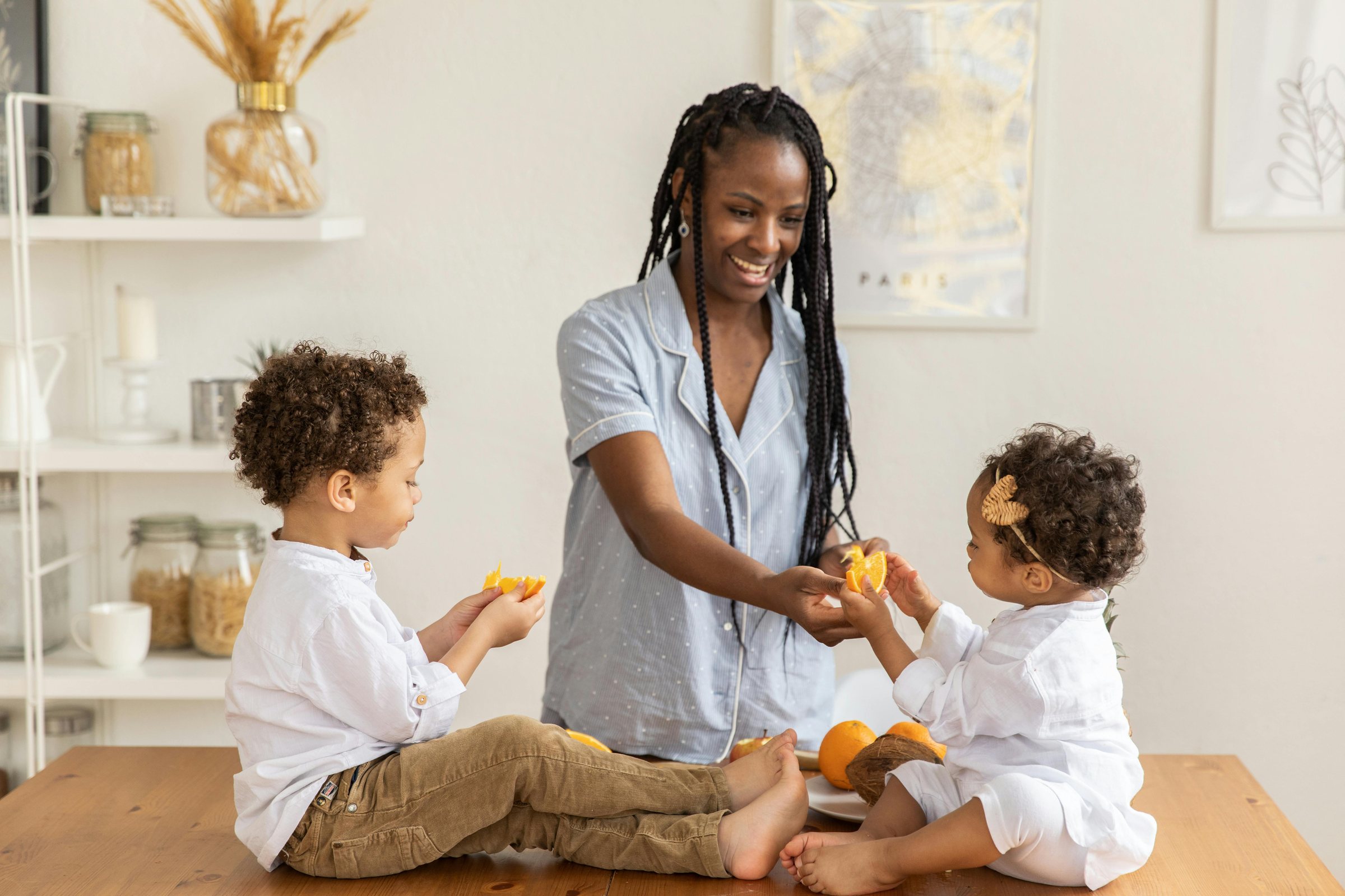 An adult sitting with two children around a table