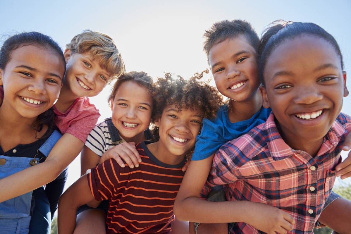 Children smiling together outside